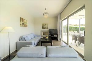 a living room with a couch and a table at Villa Caterina in Skala
