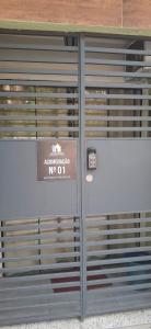 a metal garage door with a sign on it at Loft Charmoso Privativo in Volta Redonda +1 photo