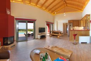 a living room with a couch and a table at Trapezaki Queen Villa in Trapezaki