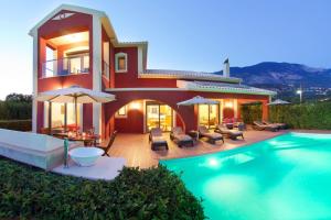 a villa with a swimming pool and a house at Trapezaki Queen Villa in Trapezaki
