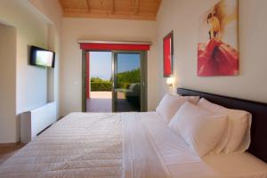 a bedroom with a large white bed in a room at Trapezaki Queen Villa in Trapezaki +27 photos