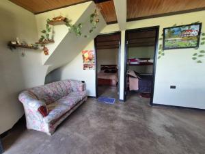 a living room with a couch and a bedroom at Rinconcito campesino in Aquitania