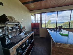a kitchen with a counter and a large window at Rinconcito campesino in Aquitania