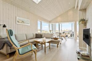 a living room with a couch and a table at LN1865-Hirtshals-Krageklit-30 in Hirtshals