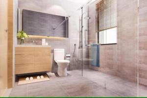 a bathroom with a toilet and a glass shower at Hotel Elysian By G K Group Near IGI Delhi Airport in New Delhi