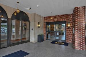 a store front with a brick wall and glass doors at The Miners 1928 Hotel in Pottsville