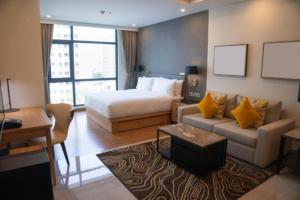 a hotel room with a bed and a couch at Hotel Elysian By G K Group Near IGI Delhi Airport in New Delhi +26 photos