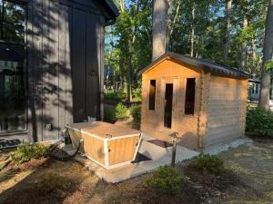 a small dog house sitting outside of a house at Maison Foxglove - Petite Acres Chateau in New Buffalo +32 photos