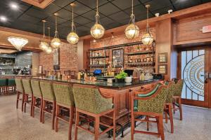 a bar in a restaurant with chairs and lights at The Miners 1928 Hotel in Pottsville