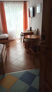 a living room with a table and a table and chairs at Hotelik Komandor in Władysławowo +44 photos