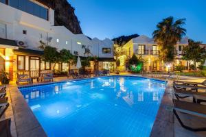a large swimming pool in a hotel at night at Lagoonia Sun Hotel in Fethiye