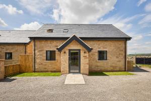 a brick house with a door in a driveway at Host & Stay - Thistle Cottage in Rochester