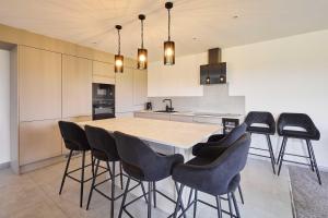 a kitchen with a large wooden table and black chairs at Host & Stay - Thistle Cottage in Rochester