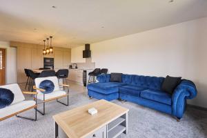 a living room with a blue couch and a table at Host & Stay - Thistle Cottage in Rochester +19 photos
