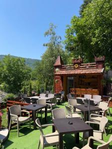 a group of tables and chairs in front of a building at Etno kutak Milojevic in Paraćin