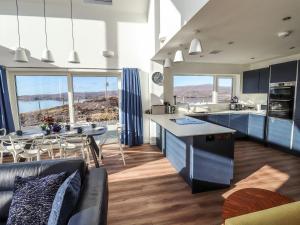 a kitchen and dining room with a view of the ocean at 8B Carrigreich in Tarbert