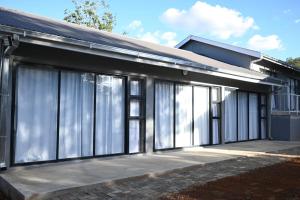 a house with large glass windows on the side of it at 49 Sannaspos in Bloemfontein