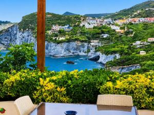 a table and chairs with a view of a body of water at Maridea - La Procella in Ponza