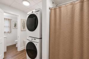 a bathroom with a washing machine and a shower at Center Field All Star Baseball Rentals in Oneonta