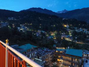 a view of a city from a balcony at night at Backpacker Inn Mcleod in Dharmsāla +9 photos