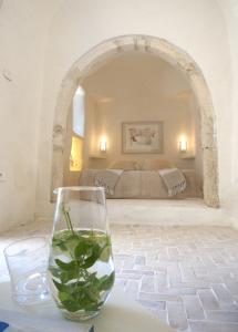 a glass of water on a table in a bedroom at Dar Bibine in Erriadh