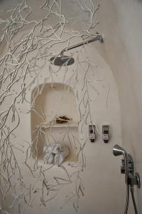 a bathroom with a tree mural on the wall at Dar Bibine in Erriadh +36 photos