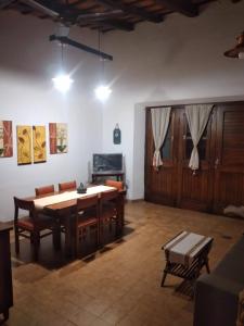 a dining room with a wooden table and chairs at La Casa de Lalo in Cafayate
