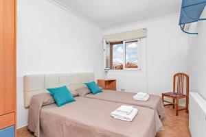 a bedroom with two beds and a window at Villa Dori by Villa Select in Punta Prima +20 photos