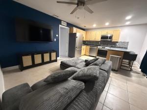 a living room with a couch and a kitchen at The Tel Ft Lauderdale in Fort Lauderdale