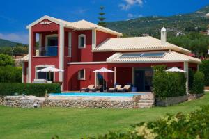 a house with a swimming pool in front of it at Trapezaki Queen Villa in Trapezaki