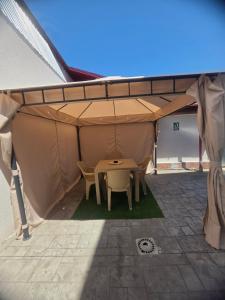 a tent with a table and chairs in it at Luxury LCF in Brăila