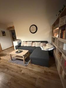 a living room with a blue couch and a table at Apartman BibKa in Donovaly