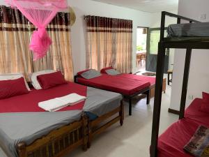 a bedroom with two bunk beds and a balcony at Cottage Wild Boar in Udawalawe