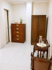 a living room with a table and a dresser at Heidi's Guesthouse in Siquijor +14 photos