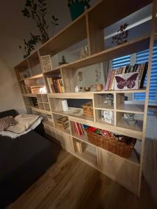 a book shelf with books and baskets on it at Apartman BibKa in Donovaly
