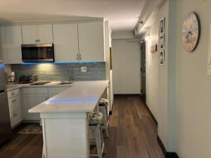 a kitchen with white cabinets and a counter top at Oceanside Inn in Daytona Beach