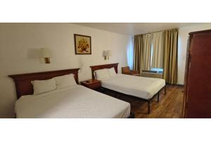 a hotel room with two beds and a window at Albuquerque Inn Near Airport I 40 in Albuquerque