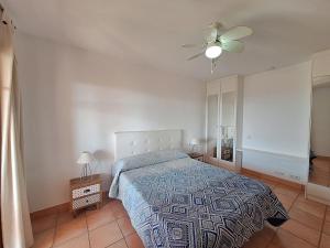 a bedroom with a bed and a ceiling fan at Harbour Lights IV in Villaricos +51 photos