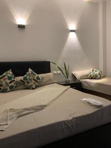 a bedroom with two beds and two lights on the wall at Voya Residence Dahab in Dahab +9 photos