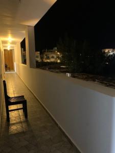 a chair sitting on a balcony at night at Voya Residence Dahab in Dahab