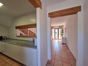 a kitchen with white cabinets and a tile floor at Harbour Lights IV in Villaricos