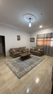 a living room with two couches and a table at v2 غرفة وصالة in Al Wajh