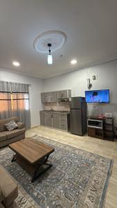 a large living room with a couch and a tv at v2 غرفة وصالة in Al Wajh