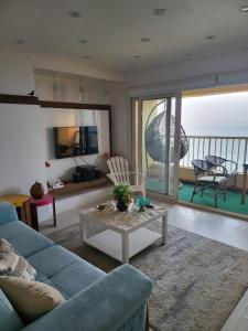 a living room with a couch and a table at Nashwa m mohamed in Ain Sokhna