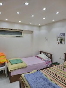 a bedroom with two beds and a window at Nashwa m mohamed in Ain Sokhna