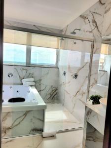 a bathroom with a sink and a shower at Hotel Itália in Paranavaí +26 photos