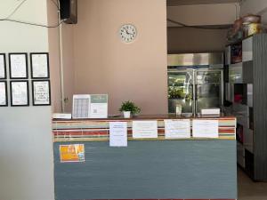 a counter in a restaurant with a clock on the wall at Amaya Bloom Resort & Spa in Pattaya +85 photos