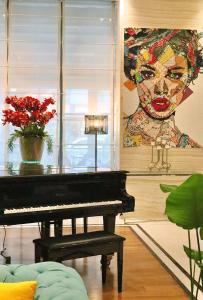 a piano in a living room with a painting at Radisson Blu Hotel, Istanbul Sisli in Istanbul