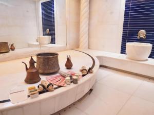 a bathroom with a counter with vases and a bath tub at Radisson Blu Hotel, Istanbul Sisli in Istanbul