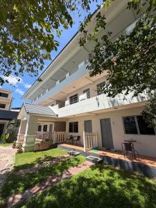 a large white building with a lawn in front of it at Amaya Bloom Resort & Spa in Pattaya